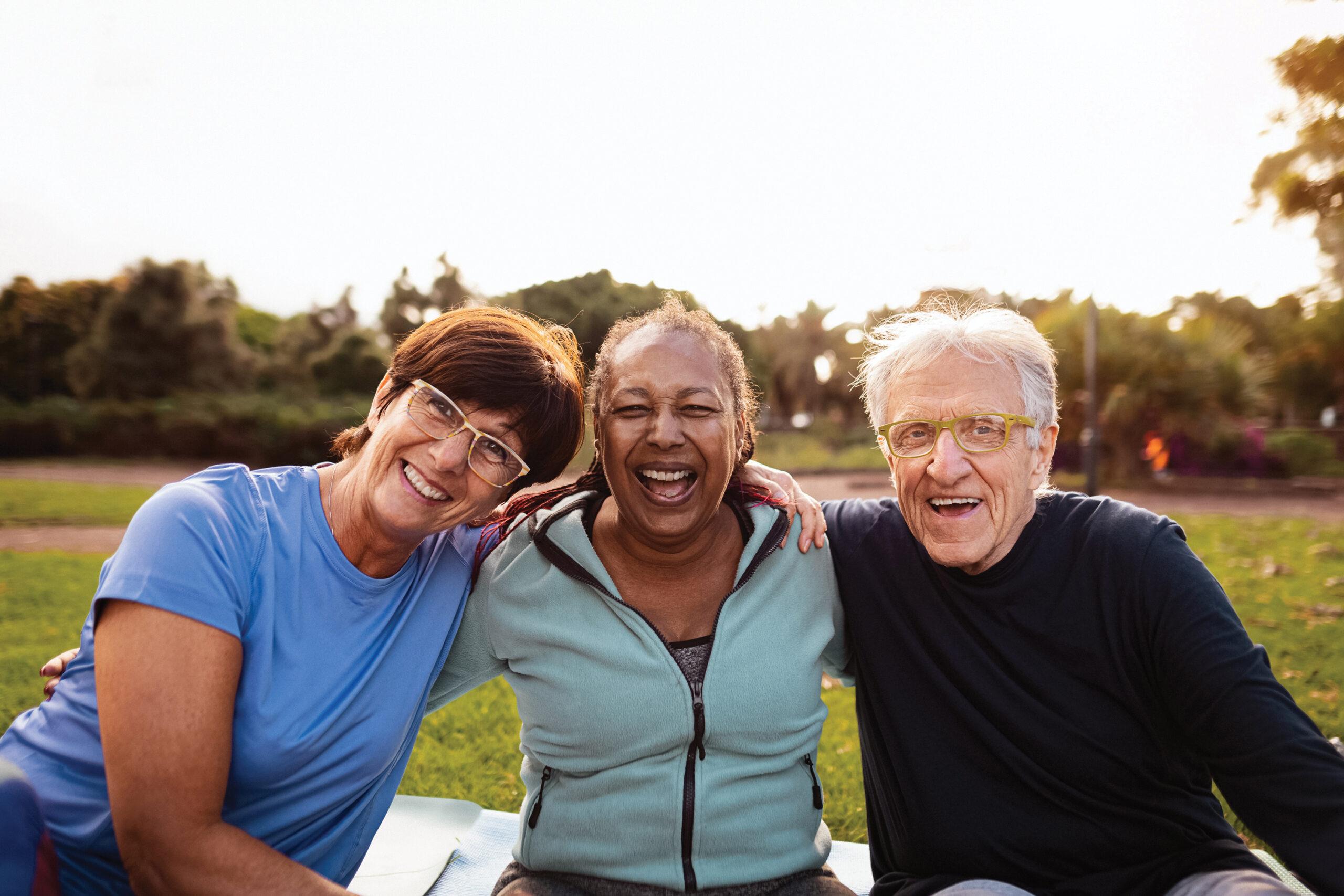 An active group of friends smiles for the camera outdoors