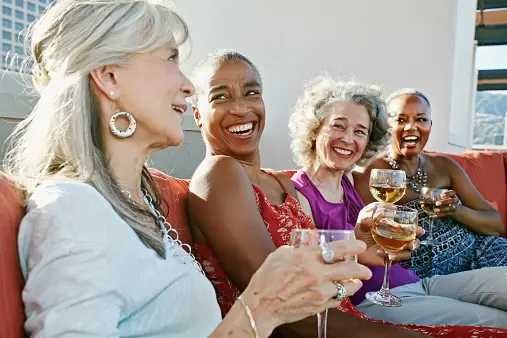 A group of friends laughs together and enjoys time outside
